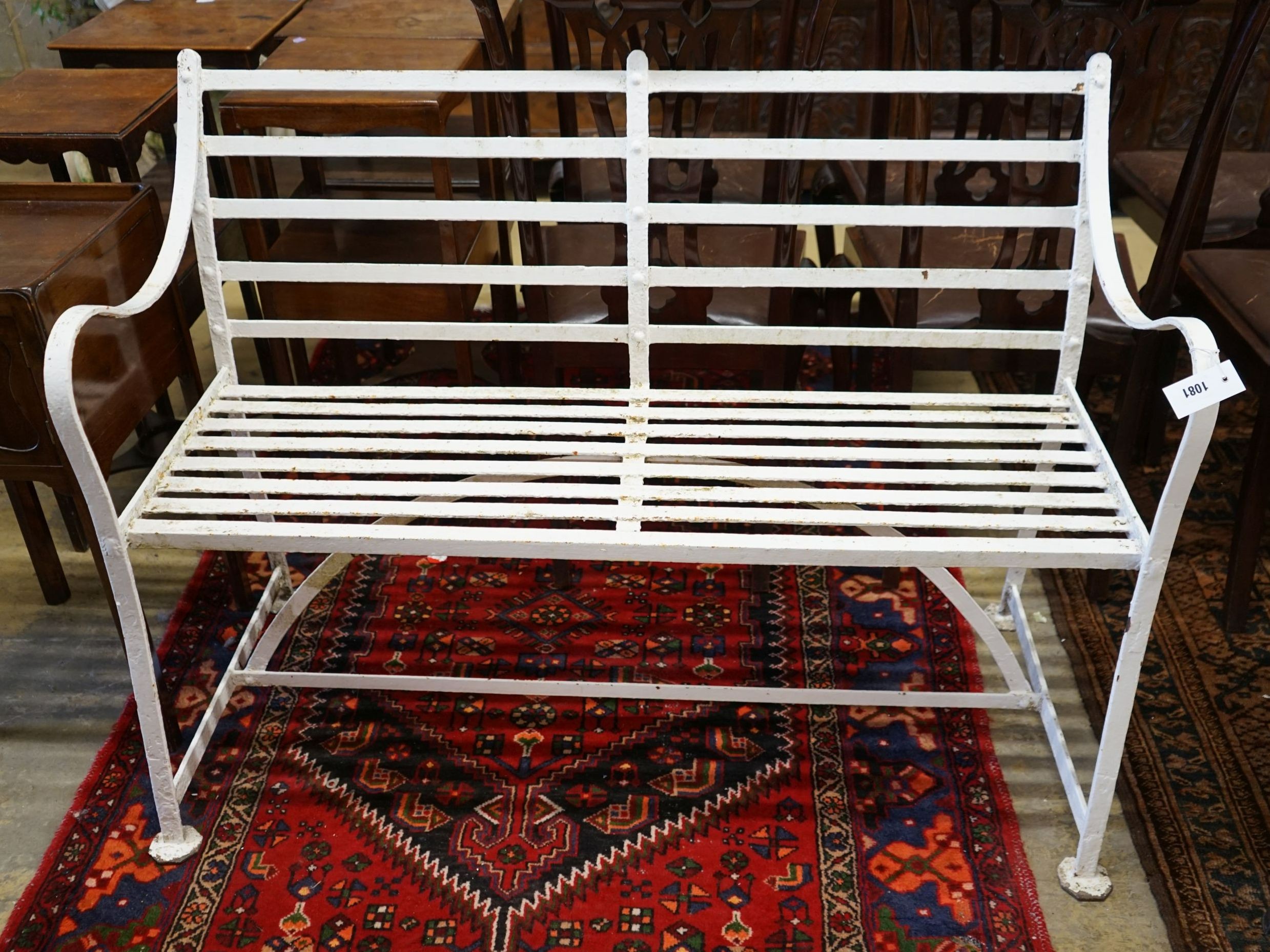 A white painted wrought iron garden bench, length 122cm, depth 48cm, height 90cm